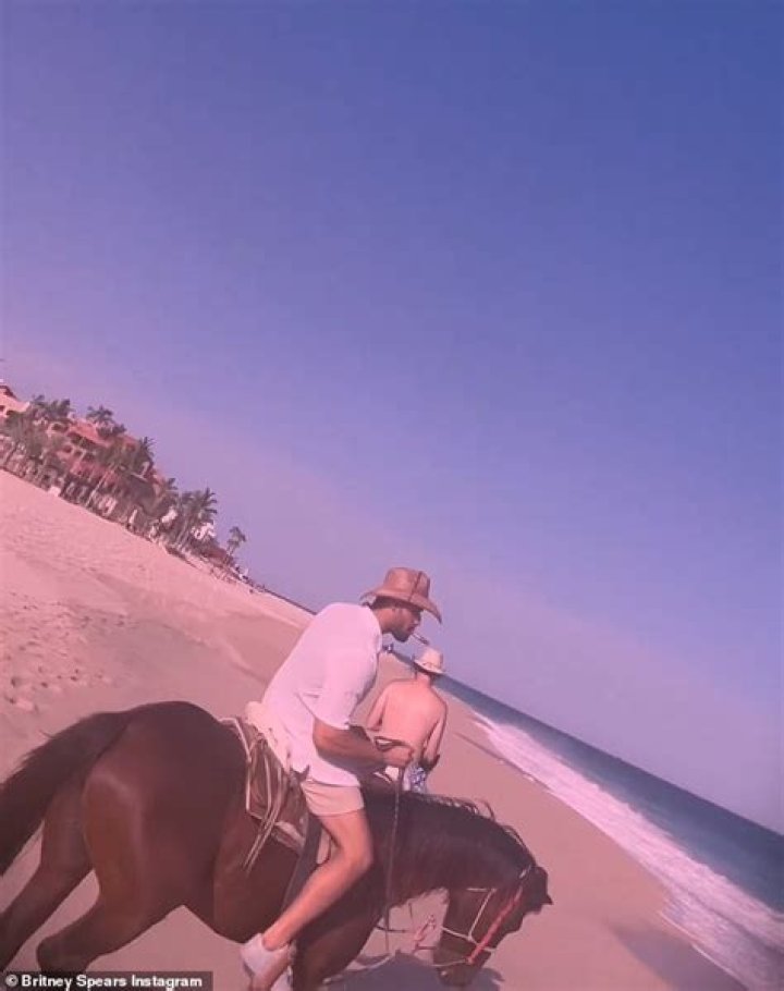 Britney Spears on a beach in Hawaii in a bikini looking pregnant
