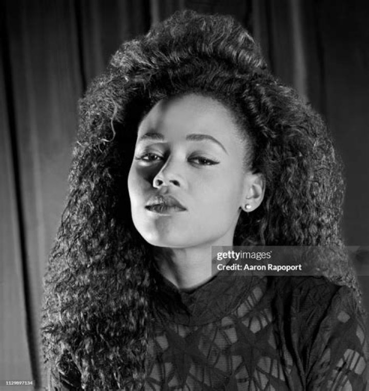 Robin Givens posing in a black shirt.