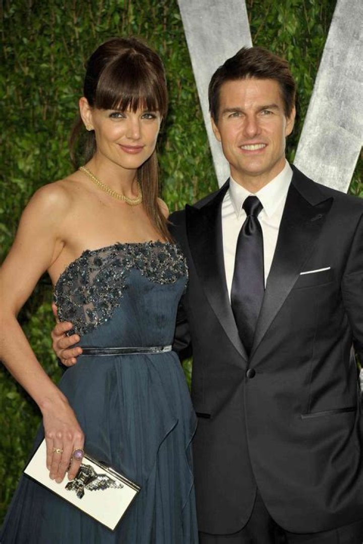 Tom holding Katie's stomach, with the caption - that womb is mine!
